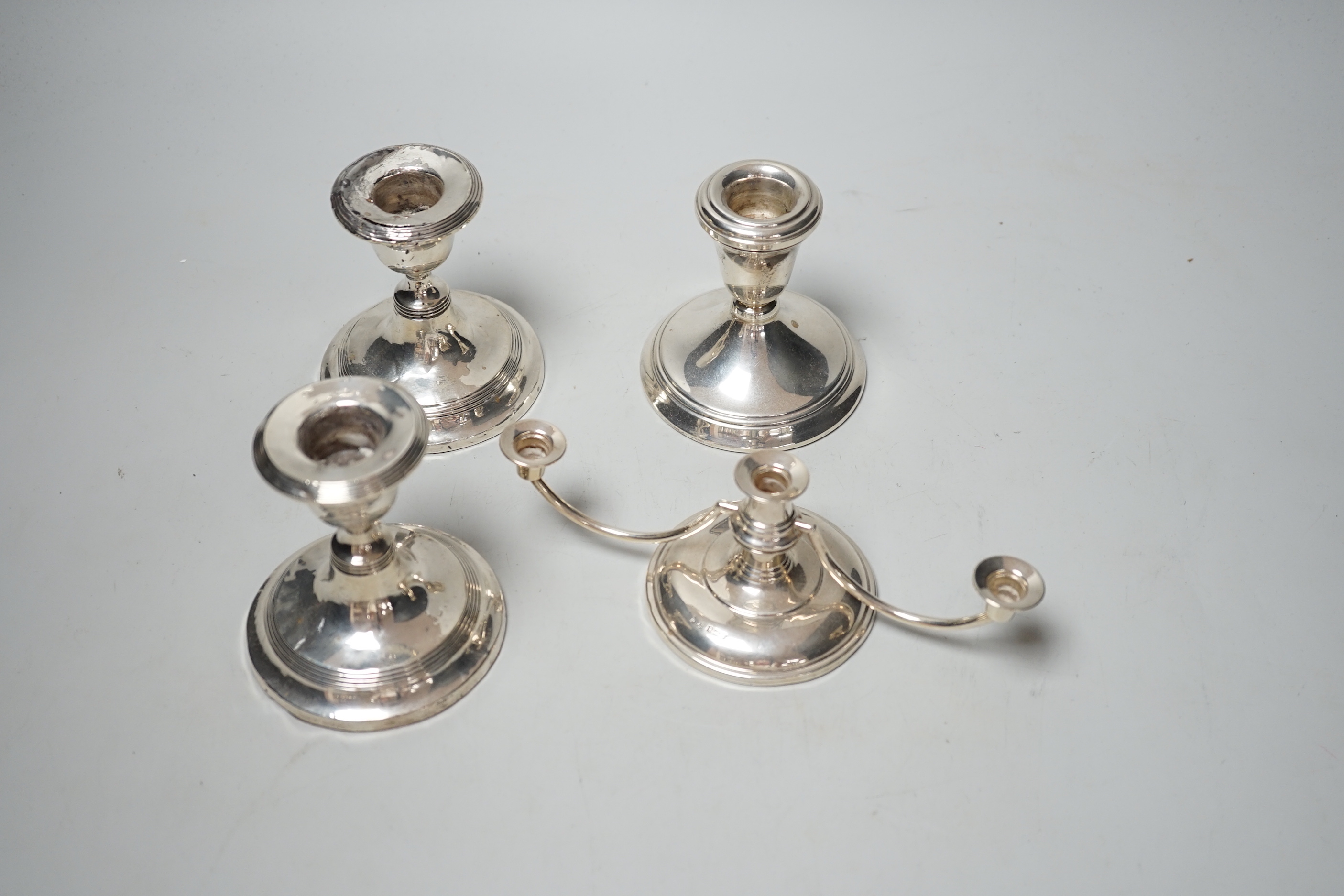 A pair of silver mounted dwarf candlesticks (a.f.), one other dwarf candlestick and a modern silver dwarf candelabrum.